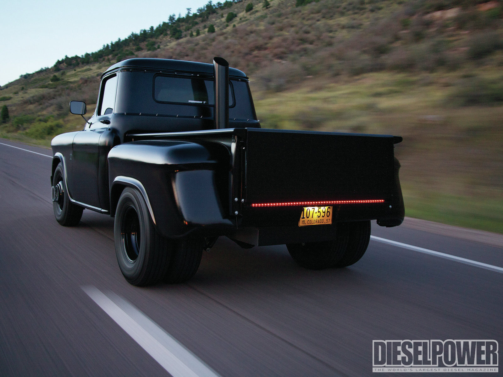 1957-chevy-pickup-in-the-black-rear-thre